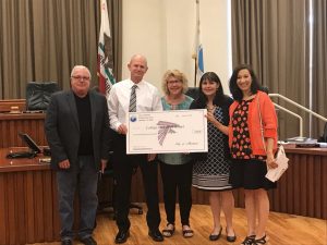 Martinez City Council presents a check to the College Park PTA for grad night activities.