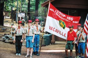 Ed Roubal holding the troop flag in 1992.