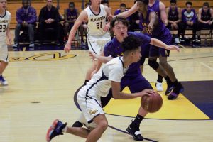 Jalen Shepard drives toward the basket against Cameron Martin