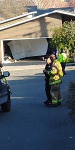 After rolling over the son, the truck then went through a garage door of a Kelly Avenue home