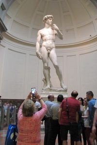 Sharon taking a picture of Michelangelo's statue of David.