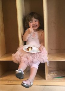 My two-year-old granddaughter Daisy enjoying Doughnut Sunday.