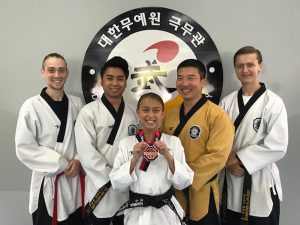 Hanna Lavino (center) holding her bronze medal 